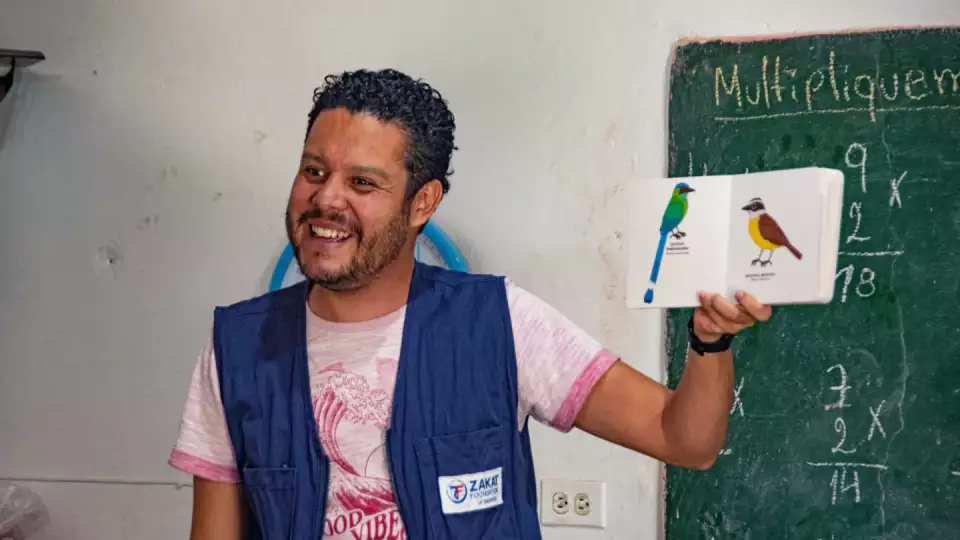 A Zakat Foundation of America representative reads an engaging story to school children in Colombia
