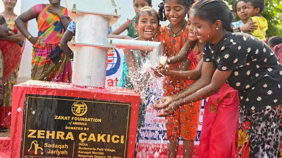 Families in India celebrate clean water from a new hand pump, and with your support, we can continue to help people lacking access to adequate water.