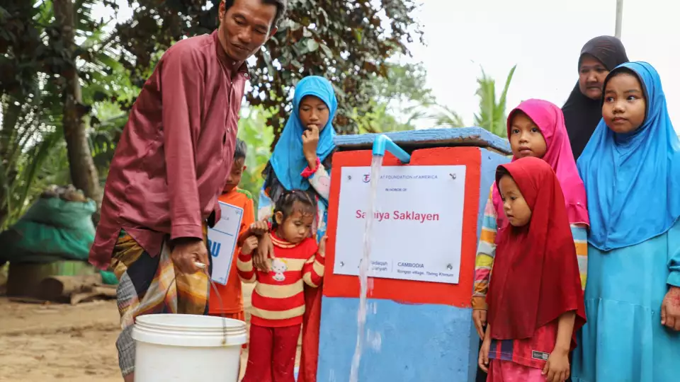 A Cambodian family collects water from our water pump to meet their daily needs.