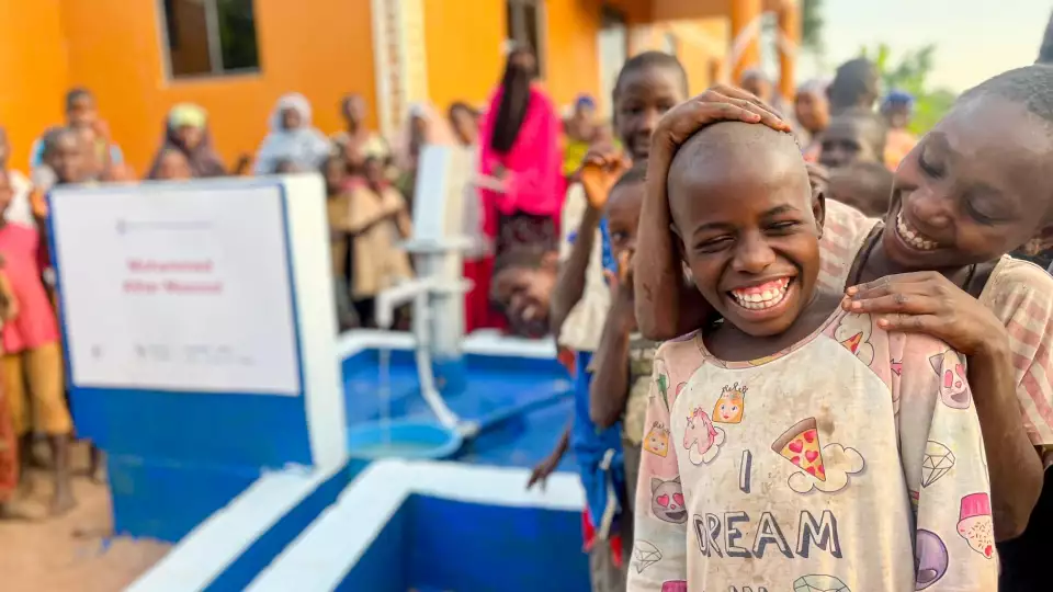 Villagers smile as they inaugurate their new water source.