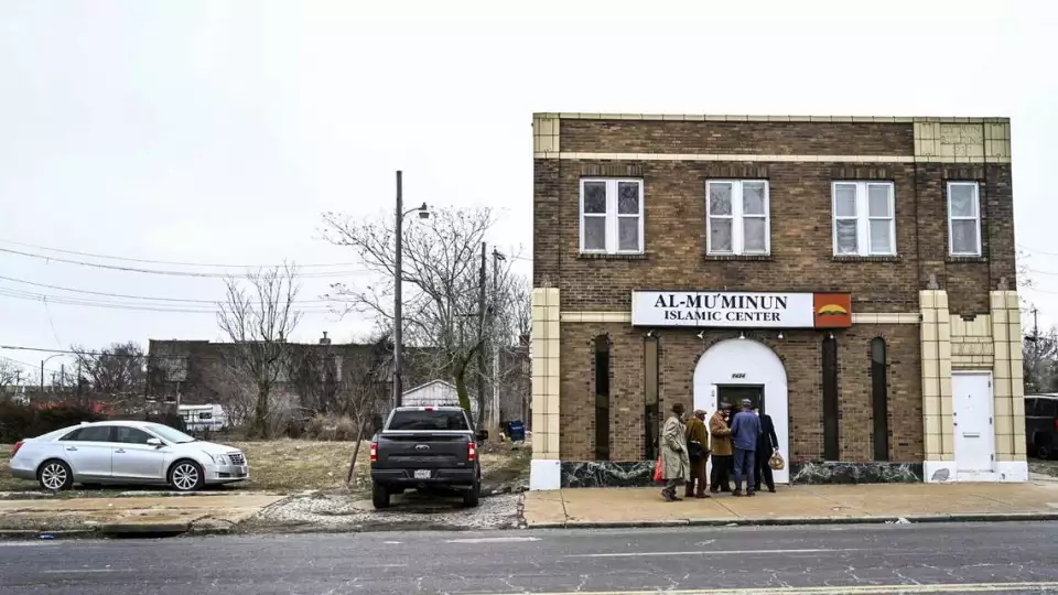Imam Jihad Mu’Min chats with friends outside of Al-Mu’minun Islamic Center after Friday prayer on North Grand Boulevard in St. Louis on Friday, Feb. 26, 2021. Photo by Cheyenne Boone, cboone@post-dispatch.com Cheyenne Boone ST. LOUIS POST-DISPATCH