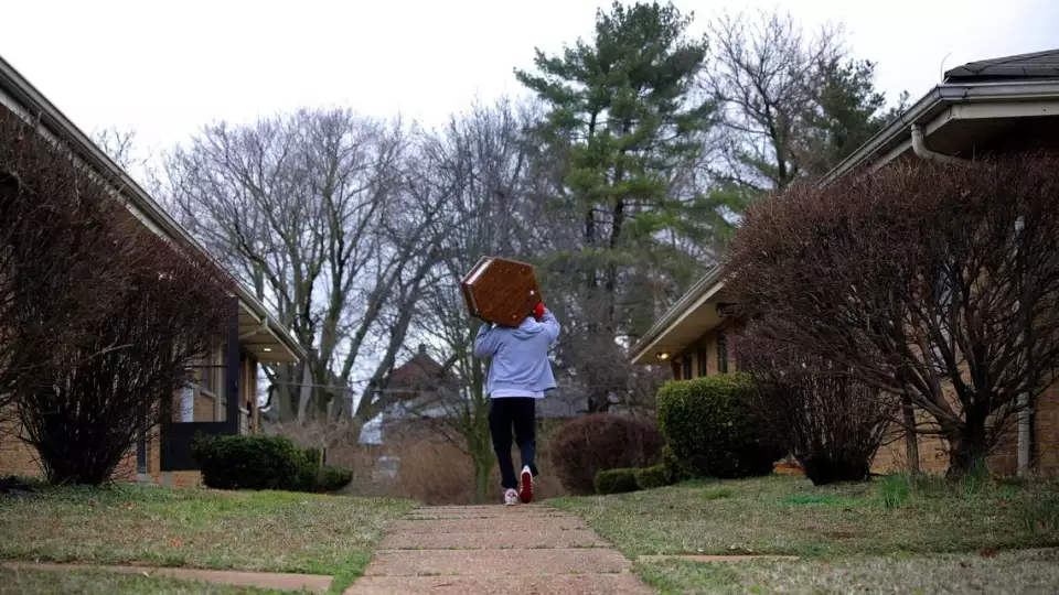 Ronnie Amiyn, housing coordinator for the Criminal Justice Ministry’s Release to Rent program, moves living room furniture on Thursday, March 11, 2021, into a south St. Louis apartment his non-profit acquired for an incoming client. The Release to Rent program finds and prepares places to live for former inmates exiting the corrections system. Photo by Christian Gooden, cgooden@post-dispatch.com Christian Gooden CHRISTIAN GOODEN ST. LOUIS POST