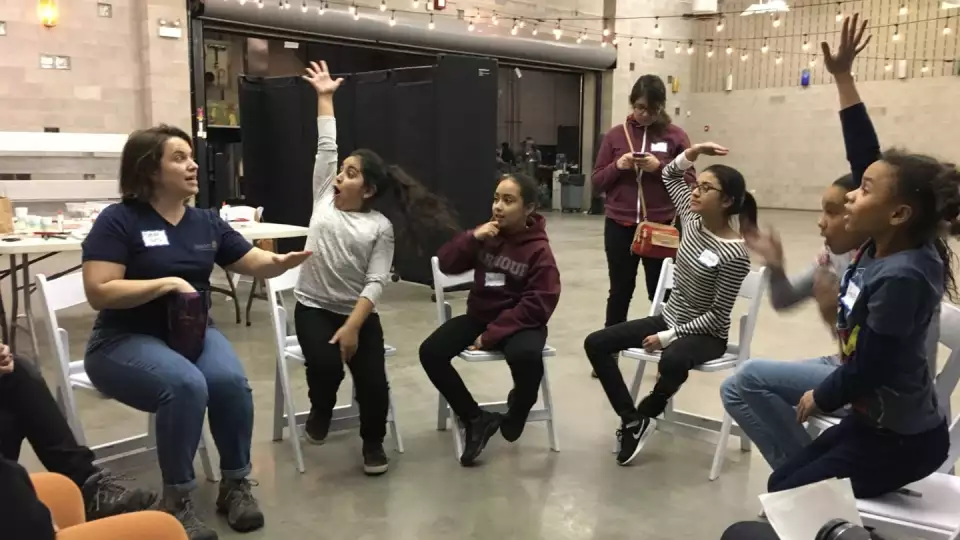 Students are excited to answer questions on a GEMS school field trip.