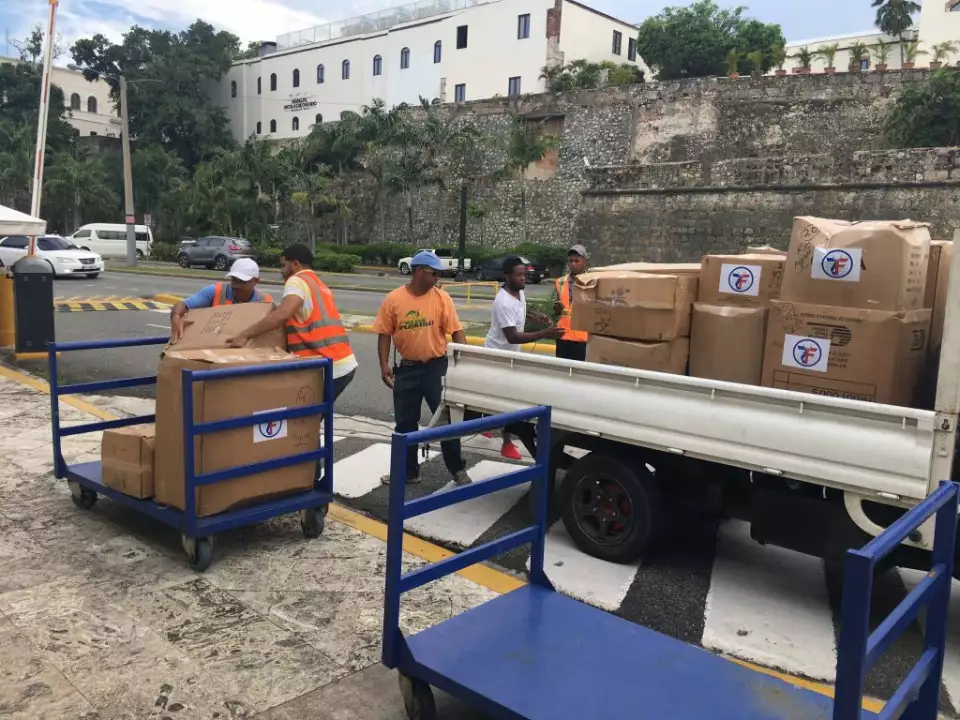 In Dominican Republic, aid workers unload packages of humanitarian aid to be placed onto ferries headed to Puerto Rico.