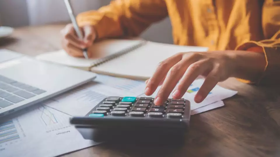 calculator person zakat cash blog 1 11 23