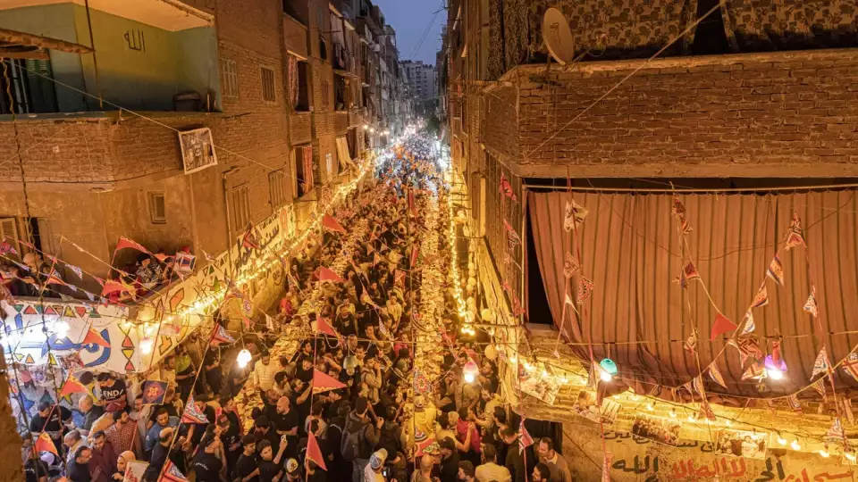 Muslims gather along a street-long table for break their Ramadan fast together in a mass "iftar" meal on the 15th day of the Muslim holy month, in the Matariya suburb in the northeast of Egypt's capital Cairo on April 16, 2022. KHALED DESOUKI, AFP Via Getty Images