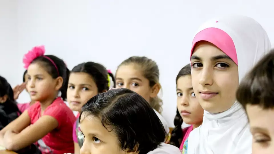 A group of orphan girls learns in school