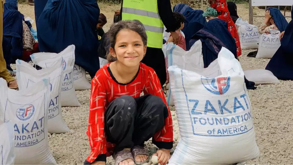 A little girl is all smiles knowing there will be a meal today.