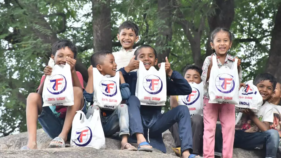 Children in India rejoice after receiving their Udhiyah meat packages.