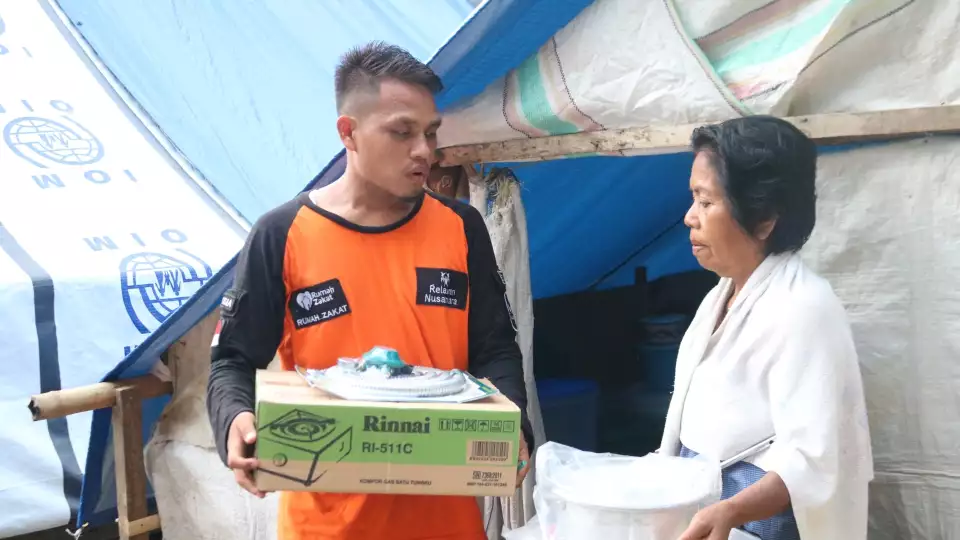 Emergency relief packages with cooking items are given to Indonesia families displaced by the earthquake and tsunami.