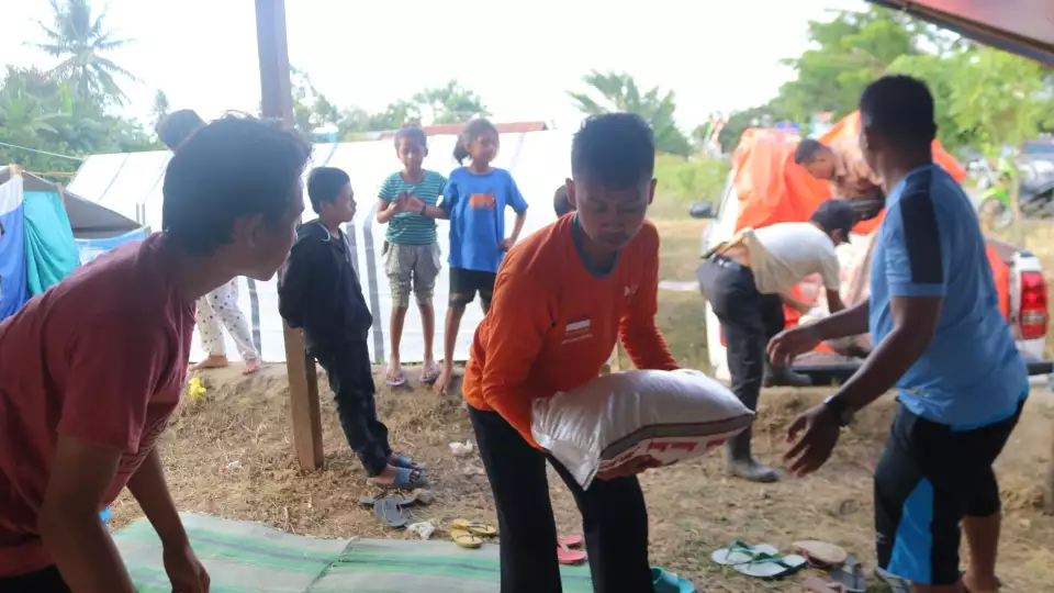 Our volunteers in Indonesia help stock emergency relief items for families affected by the earthquake and tsunami.
