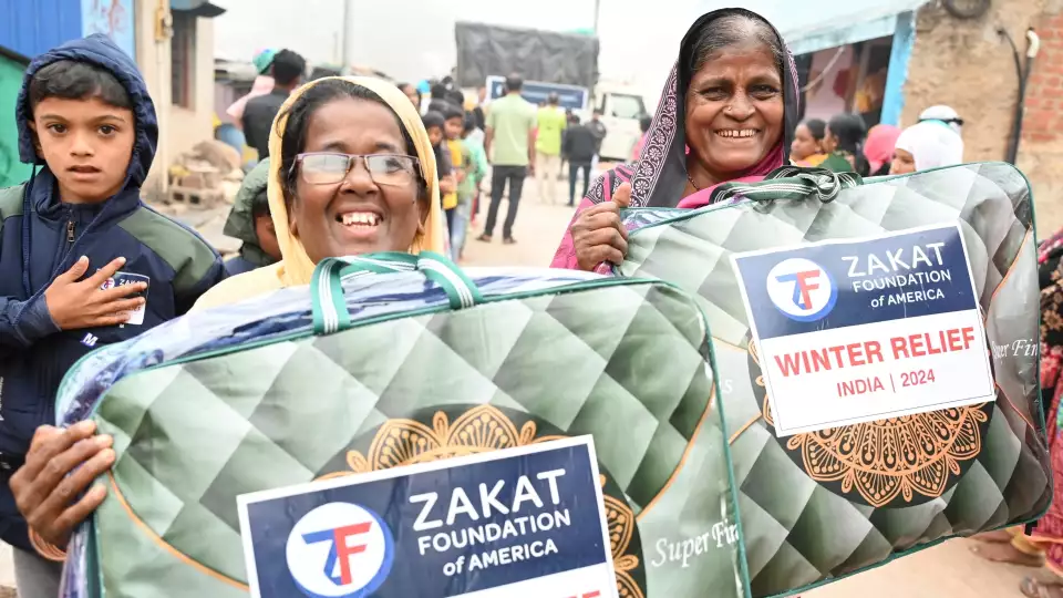 Winter relief brings joy to families in India who collect blankets at our distribution.