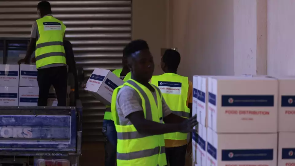 Trucks being loaded with food packages for Libyan families facing food insecurity.